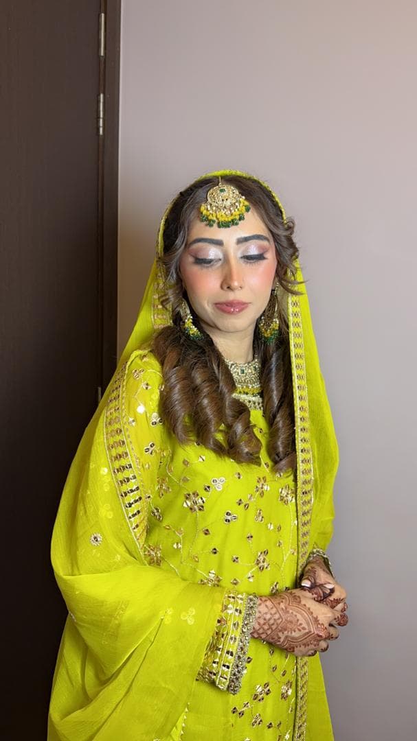 Bridal mehndi look in a neon lime outfit with gold jewellery