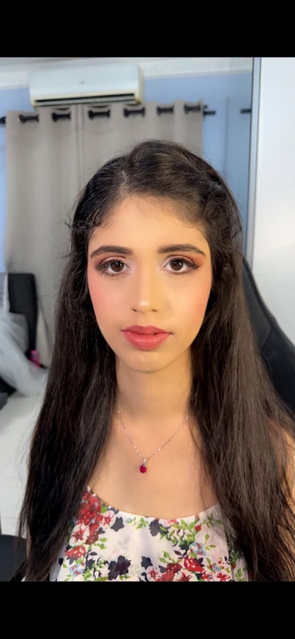Soft glam look with coral lips and a natural finish