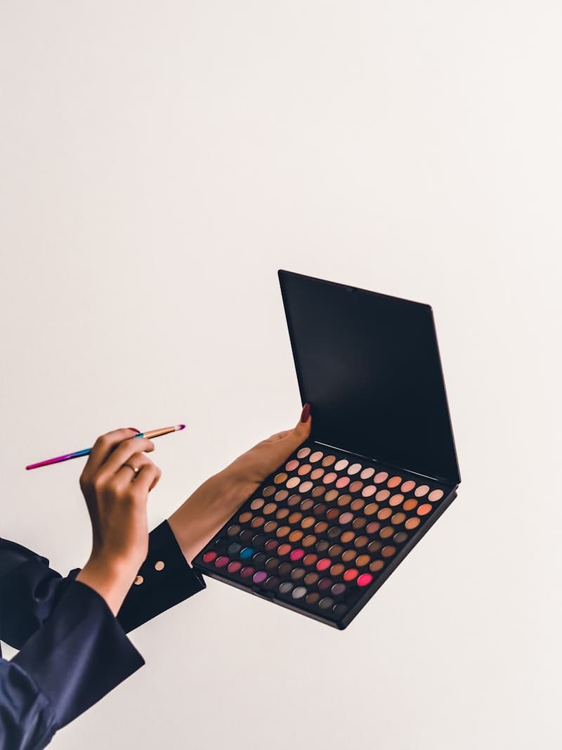 Eyeshadow palette and brush in hand